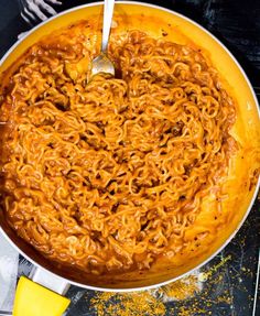 a large pot filled with noodles on top of a table