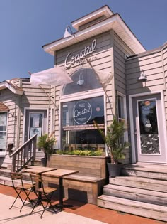 the outside of a restaurant with tables and chairs