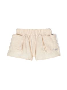 beige cotton interlock twill weave mini logo tag elasticated waistband two side patch pockets wide leg Relaxed Fit Cotton Neutral Shorts, Neutral Cotton Relaxed Fit Shorts, Summer Cotton Bottoms In Neutral Color, Summer Cotton Shorts In Neutral Color, Neutral Cotton Summer Shorts, Solid Cotton Shorts With Ribbed Waistband, Casual Cream Cotton Shorts, Beige Summer Bottoms With Patch Pockets, Cream Shorts With Elastic Waistband And Relaxed Fit