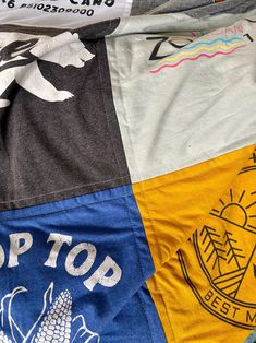 several different colored shirts laying on top of each other with the words stop top printed on them