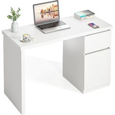 a laptop computer sitting on top of a white desk next to a cup and plant