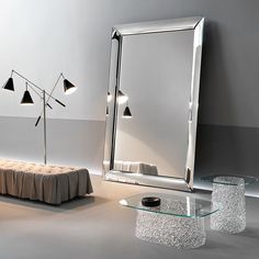 a living room scene with focus on the mirror and table, lights in the background