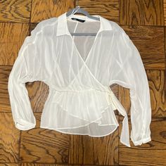 New Condition. Never Worn! Zara Semi-Sheer White Blouse. Crossover Style With Elastic Waistline And Tie Detail Chic White V-neck Wrap Top, Chic White Wrap Top, Sheer Long Sleeve Top For Day Out, Chic White Long Sleeve Wrap Top, Sheer Long Sleeve Blouse For Day Out, Long Sleeve Wrap Top For Spring Party, Spring Party Long Sleeve Wrap Top, White V-neck Chic Wrap Top, Chic White Summer Wrap Top