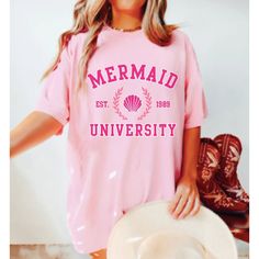 Get ready to fall in LOVE with your new Mermaid University aesthetic comfort colors shirt. It's the cutest and most comfortable way to show off the latest styles. Also makes a great gift! * PRODUCT DETAILS * ✺ 100% cotton ✺ Medium weight fabric  ✺ Wash and dry normally (on cool for best results) ✺ Designed and printed in the USA ✺ Due to different monitor screens, colors may vary ✺ * SIZING * ✺ FOR AN OVERSIZED FIT, SELECT TWO OR THREE SIZES UP FROM YOUR NORMAL SIZE ✺ ✺ Sizing is unisex ✺ Size g Cotton Mermaid Top For Summer, Mermaid Tshirt, Vsco Beach, University Aesthetic, Mermaid Shirt, Mermaid Outfit, Mermaid Aesthetic, Pastel Outfit, Aesthetic Shirt