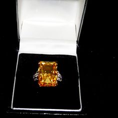 4.00ct Rectangular Octagonal Citrine Simulant Ring With 0.09ctw Round White Zircon Details At Sides. Solitaire Style. Prong Faceted. 18k Yellow Gold Over Sterling Silver. Size 7. Measures Approximately 3/4" Long And 1/2" Wide. Finished Under Gallery. New With Tags. Luxury Yellow Gemstones With Accent Stones, Luxury Yellow Diamond Ring Hallmarked, Luxury Brilliant Cut Citrine Diamond Ring, Luxury Yellow Diamond Hallmarked Ring, Luxury Yellow Diamond Gemstones, Yellow Gold Cubic Zirconia Gemstones For Formal Occasions, Formal Yellow Gold Cubic Zirconia Gemstones, Luxury Yellow Gemstones For Wedding, Yellow Diamond Fine Jewelry Gemstones