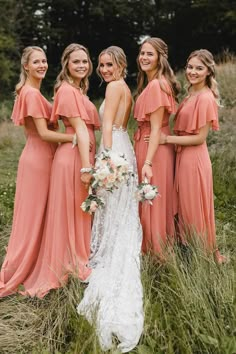 the bride and her bridesmaids pose for a photo