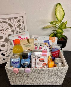 a basket filled with lots of different types of items next to a potted plant