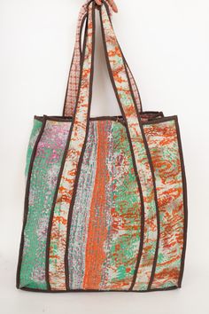 This bag is made from a vintage hand-stitched Kantha quilt. We make only 1-2 bags from each quilt and every one of them is one of a kind! Details: Shell fabric- Vintage quilted cotton Kantha 1. width (cm) - 35 2. height (cm)- 45 3. depth (cm) - 35 4. weight (g)- 0.400 kg 5. length of shoulder (cm) -25 cm Care instructions: Dry clean or Hand-wash in warm water. Drip dry. How it's made: Kantha quilts are made using numerous layers of recycled silk or cotton saris which are hand-stitched in the tra Foldable Bag, Water Drip, Kantha Quilts, Women Shoulder Bag, Vintage Kantha, Warm Blankets, Work Bag, Drip Dry, Kantha Quilt