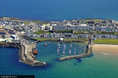 an aerial view of a harbor with boats in the water and buildings on the shore