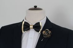 "This unique and eye-catching leather bow tie is handcrafted in Slovenia in Europe with high quality soft Italian leather. It suits a variety of styles, from a casual look with a simple shirt to formal wear. We also offer matching pocket square cards and lapel flower pins/boutonnieres that you can find in our shop. Item Details: BOUTONNIERE: 5cm, 2\" MENS BOW TIE: * Pre-tied bow size: 4\" x 2.5\" approx. * Adjustable fabric strap with metal hardware to neck size: 14\" - 19.5\" BOYS BOW TIE: * Pr Bow Tie For Men, Gold Bow Tie, Toddler Bow Ties, Wedding Bow Tie, Leather Bow Tie, Groomsmen Bowtie, Black Color Combination, Baby Bowtie