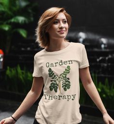 This garden themed jersey knit, short sleeve tee fits like a well-loved favorite. It is made from soft, Airlume combed and ring-spun cotton. These shirts have ribbed knit collars to bolster shaping and side seams to help retain shape. * 100% Airlume combed and ring-spun cotton* Tear away label * Lightweight fabric (4.2 oz/yd² (142 g/m * Tear away label * Runs true to size * Fiber composition: Solid colors are 100% cotton except for Ash - 99% cotton and 1% polyester, heather colors are 52% cotton Organic Short Sleeve T-shirt For Spring, Green T-shirt With Plant Print For Gardening, Organic Green Short Sleeve Top, Green Organic Relaxed Fit T-shirt, Casual T-shirt For Gardening In Spring, Relaxed Fit T-shirt For Gardening In Spring, Organic Cotton T-shirt For Spring, Casual Spring T-shirt For Gardening, Green Graphic Print T-shirt For Gardening