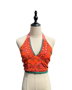 This vibrant, hand-embroidered bikini halter top offers stylish Boho-inspired fashion with its colorful threads and sequin embellishments. Paired with jeans or a skirt, this is the perfect summer top to stand out in and make a statement. The lining is a contrasting color to give it a unique, eye-catching look. One Size Made in India Care Instructions: Dry clean only Girl In The Mirror, Colorful Threads, Inspired Fashion, Summer Top, Bright Orange, The Mirror, Perfect Summer, Halter Top, Bright Pink