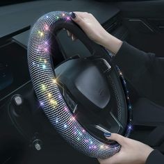 a woman is holding the steering wheel cover