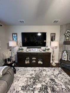 a living room with a large flat screen tv on the wall