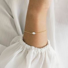 This sleek gold chain bracelet with a graceful oval-shaped mother of pearl centerpiece complements all styles. This sweet bracelet is perfect for mixing in a stack or wearing solo for a minimal look. Made with recycled metals, for the earth friendly at heart. Recycled 14k gold filled Available in 6.5" or 7.5" lengths Both lengths include a 1/2" long extender chain Mother of Pearl is 4mm x 6mm Minimalist Oval Bracelets For Everyday Wear, Dainty Oval Bracelet For Everyday, Minimalist Oval Chain Bracelet Gift, Dainty Oval Bracelets As Gift, Dainty Oval Bracelets For Gifts, Dainty Oval Bracelet As Gift, Dainty Oval Bracelet For Gift, Dainty Oval Chain Bracelet Gift, Elegant Oval Chain Bracelet For Everyday