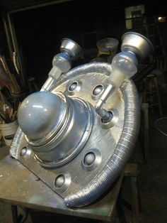 a metal object sitting on top of a wooden table