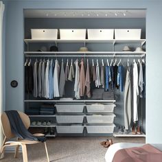 an organized closet with clothes and shoes on the shelves, along with a rocking chair