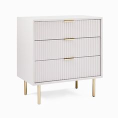 a white and gold dresser with two drawers on one side, the top drawer is closed