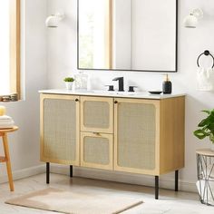 a bathroom with a sink and mirror on the wall next to a rug in front of it