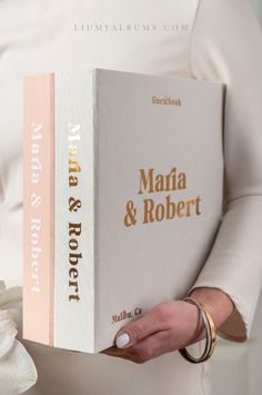 a woman holding a book in her hands with the title'martha & robert'written on it