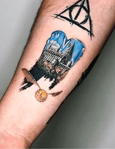 a harry potter tattoo with hogwart's castle in the middle and hogwarts crest on his arm