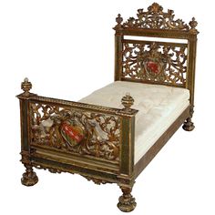 an ornate gold bed frame with white linens and red hearts on the headboard