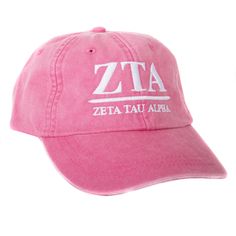 a pink hat with the word zeta in white on it, against a white background