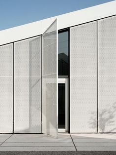 a white building with an open door in front of it