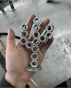 a person holding some metal parts in their hand