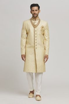 Ivory and golden sherwani with floral frame embroidery. Paired with an inner kurta and churidar. - Aza Fashions Gold Kurta With Pallu For Reception, Ceremonial Gold Kurta With Naqshi Details, Ceremonial Gold Kurta With Naqshi, Gold Sherwani With Pallu For Reception, Gold Sherwani For Reception At Diwali, Gold Bandhgala For Eid Reception, Gold Kurta With Chikankari Embroidery For Reception, Elegant Gold Sherwani With Chikankari Embroidery, Gold Traditional Wear With Naqshi For Reception