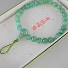 Green Banded Agate Bracelet Characteristics of the product Material : Green Banded Agate, Silk elastic cordWrist size : about 17cm (Stretch)We adjust the size to your wrist for a fee.Head beads : about 10mmMain beads : about 7mm Handmade in Kyoto, JAPAN About Green Banded Agate Green agate is considered a healing stone with a multitude of properties. It is believed to dispel negative energies, boosting self-confidence and self-esteem. It is also associated with health, luck, harmony, beauty, and Jade Bracelets With Round Beads For Gifts, Adjustable Jade Jewelry For Meditation, Agate Gemstone Beads Crystal Bracelet As Gift, Jade Beaded Bracelets With 8mm Beads As Gift, Hand-strung Jade Bracelet Perfect As A Gift, Hand-strung Agate Crystal Bracelet As Gift, Hand-strung Jade Bracelet As A Gift, Agate Bracelet With 108 Beads, Hand-strung Jade Bracelets As Gift