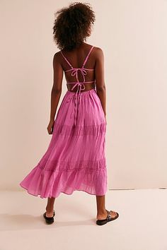 Just as effortless as it is versatile, this wear-everywhere maxi from our free-est collection is featured in a billowy, tiered silhouette with smocked detailing at the bodice and front tie detailing for added dimension. * Open back design * Adjustable, tie-back style * Lined | Taking Sides Maxi Dress by free-est at Free People in Pink, Size: L Breezy Ruffled Maxi Dress For Brunch, Breezy Maxi Dress With Ruffles For Brunch, Flowy Sundress With Smocked Back, Tiered Maxi Dress With Tie Back, Tiered Maxi Dress With Tie Back For Brunch, Tiered Vacation Dress With Tie Back, Ruched Tiered Skirt Midi Dress For Day Out, Beach Maxi Dress With Ruffle Hem And Tiered Skirt, Tiered Midi Dress With Ruffled Skirt For Beach