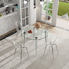 a glass dining table with four chairs around it