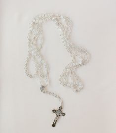 a white rosary with a cross on it