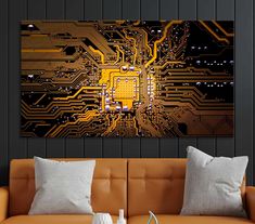 a couch with two pillows on it and a painting in the background that looks like a circuit board