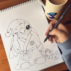 a drawing of a cartoon character is being drawn by someone's hand while holding a pencil