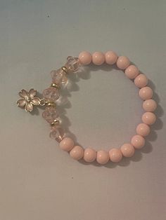 Cute pink bracelet with sakura flower charm Cute Bracelet Ideas Pink, Cheap Flower-shaped Bracelets For Vacation, Jewellery Beads Ideas, Bracelet Making Inspiration, Fancy Beaded Bracelets, Bead Accessories Ideas, Pink Bead Bracelet Ideas, Cute Bracelet Ideas Diy, Bracelet Ideas Flower