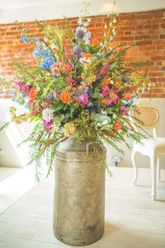 a vase filled with colorful flowers on top of a wooden table