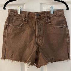 Relaxed High Waisted Jean Shorts. Distressed Edges With Button Fly With Button Closure. Perfect Color For Summer-To-Fall Outfits. Color: Washed Chocolate (Brown) Size: 26 Waist: 13.5” Rise: 11” Brown Cutoff Shorts For Summer, Summer Cutoff Brown Shorts, Brown Bottoms With Button Closure For Spring, Spring Brown Bottoms With Button Closure, High Rise Brown Cotton Shorts, Brown Jean Shorts, Cut Off Jean Shorts, High Waisted Jean, Brown Jeans