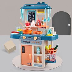 a toy kitchen with pink appliances and accessories