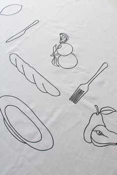 a table cloth with an image of food and utensils drawn on the fabric