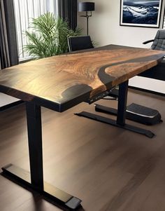 a wooden table sitting on top of a hard wood floor next to a black chair