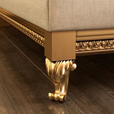 a close up view of a bed with gold trimmings on the headboard and foot board