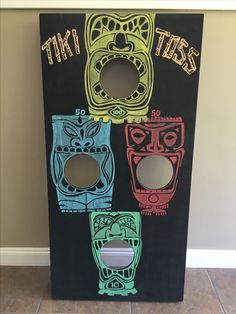 an image of three tiki boxes painted on the side of a wall with holes in it