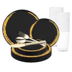 a set of black and gold dinnerware with fork, knife and spoon rest on top of each other