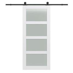 a white sliding door with glass panels and black hardware on the bottom half of it