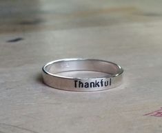 { sterling stacking rings . Personalize rings with names, dates, mantra, inspirational message, etc. } mom rings . personalized name rings . child name stackable rings {ONE} simple sterling ring beautiful for stacking with other rings . custom name(s), date, and or message up to 20 characters . approx. 3mm in width . message only stampable on the outside of the ring {all rings come packaged and ready to gift ~ if shipping directly to gift recipient and you want me to include a note from you just Personalized Inspirational Ring Jewelry, Inspirational Personalized Ring Jewelry, Inspirational Adjustable Ring, Adjustable Spiritual Stackable Rings As Gift, Adjustable Stackable Rings With Custom Name, Custom Name Adjustable Stackable Rings, Adjustable Stamped Stackable Rings For Everyday, Everyday Meaningful Hand Stamped Stackable Rings, Adjustable Inspirational Rings For Everyday