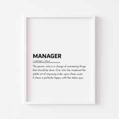 a white framed poster with the words manager in black and white on it's side