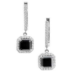 Square black diamond and round white diamond dangle earrings. 2 center square black diamonds with white diamond halos and diamond clip post tops. Designed in the Peter Suchy Workshop. 2 square black diamonds, Included approx. 2.97cts 60 round brilliant cut diamonds G-H VS, approx. .32ct 18k White Gold Tested: 18k 4.7 grams Top to Bottom: 23.7 to 15/16 Inch Width: 8.4mm or 1/3 Inch Depth or thickness: 5mm White Diamond Dangle Earrings, Antique Wedding Bands, Diamond Sapphire Engagement Ring, White Diamond Earrings, Black Diamond Earrings, Antique Engagement Rings Vintage, Antique Bracelets, Vintage Sapphire, Gold Dangle Earrings