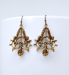 "Here is a beautiful pair of handmade earrings featuring ornately detailed Victorian style filigree with flowers and leaves design. Earrings are styled with solid antique brass french hook style ear wires. Earrings measure 1 5/8\" long end to end and have a width just shy of 1\". Lightweight and comfortable. These earrings are lead and nickel free. Please feel free to ask questions. Customization and custom orders are always welcome. SimpleSoulStudios cares about the environment! All jewelry shi Vintage Earrings Victorian, October Jewelry, Art Nouveau Earrings, Antique Brass Chandelier, Art Deco Jewelry Vintage, Faberge Jewelry, Art Nouveau Earring, Deco Earrings, Bronze Earrings